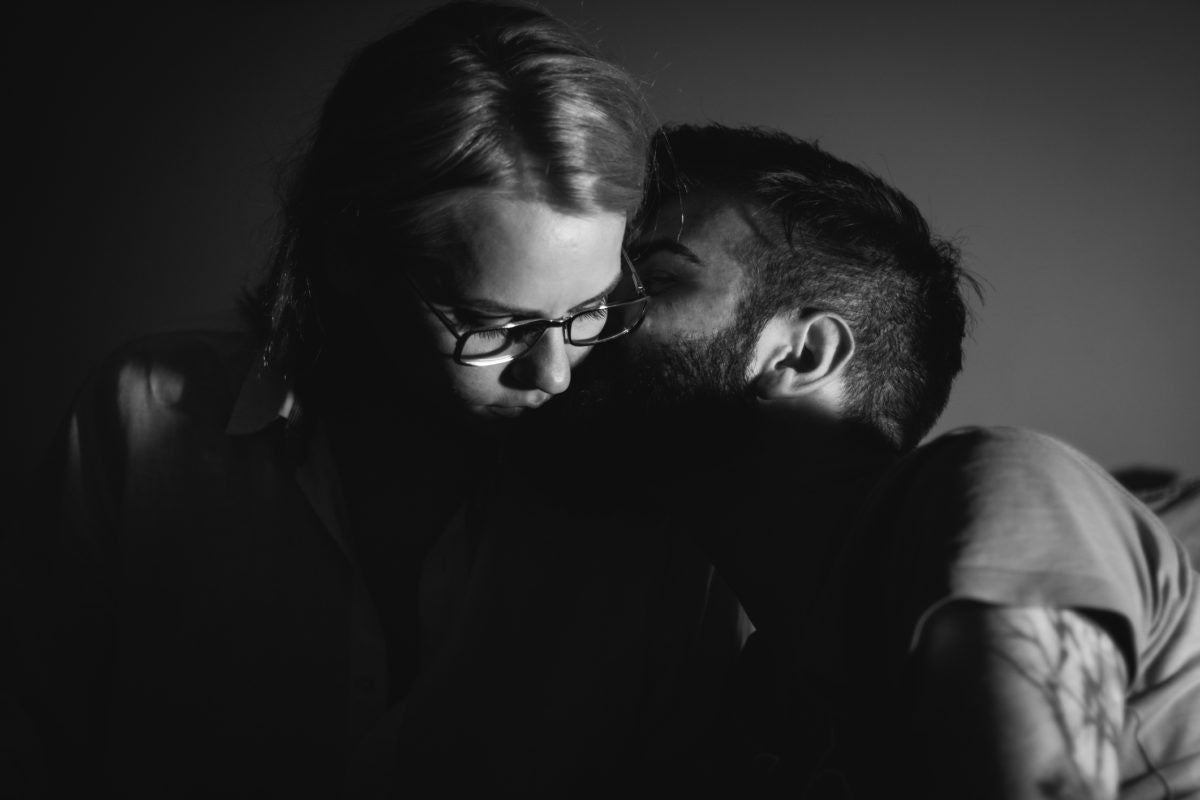man kissing a woman