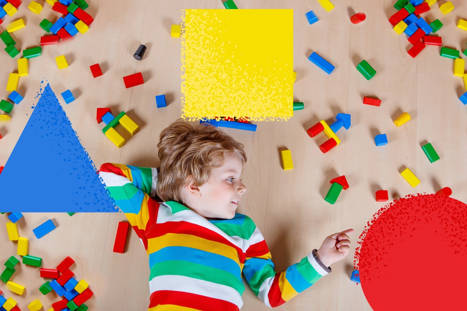 child lying in middle of lego blocks