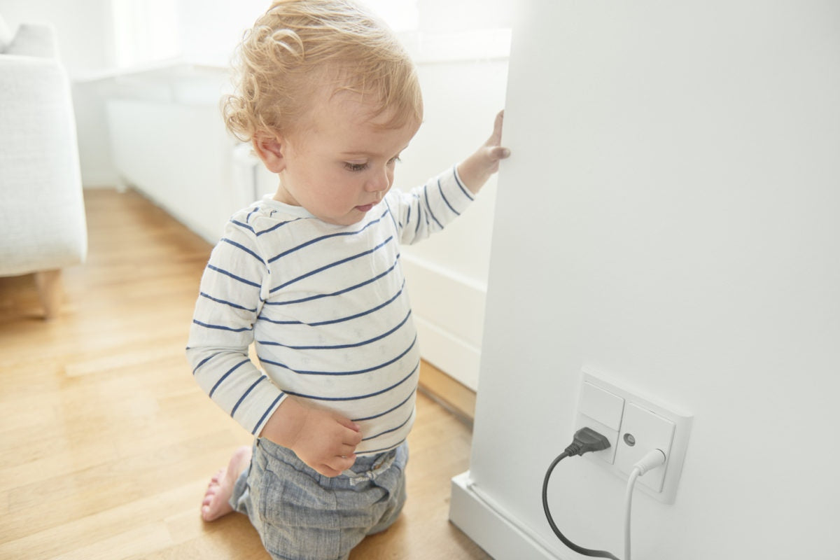 boy looking at electric outlets