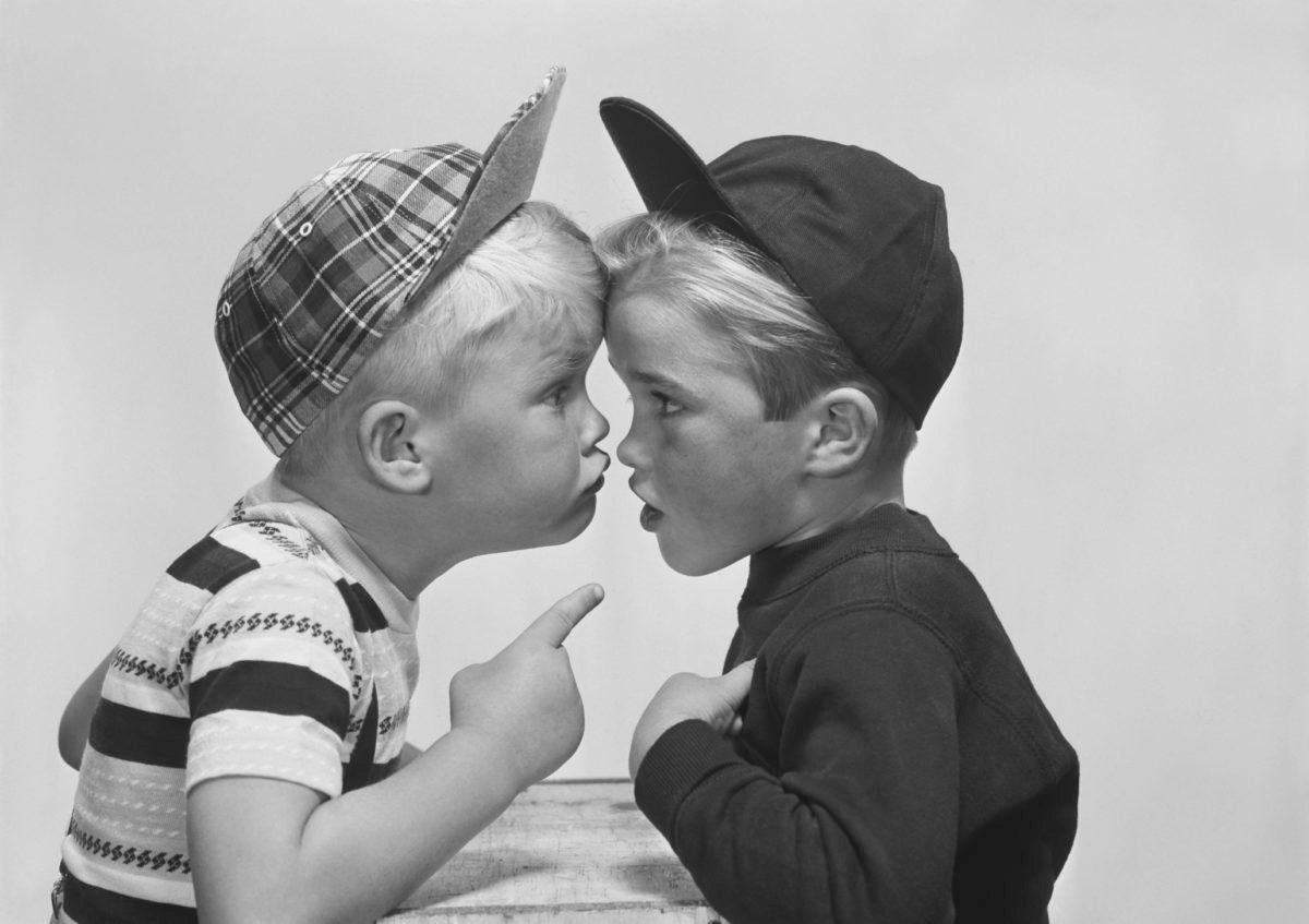 old picture of two boys looking at each other one pointing