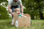 dad pushing a young boy in a cardboard car box