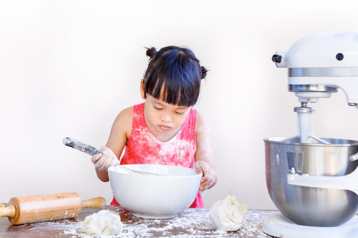 young girl baking mess