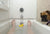person in bathtub while a dog is looking