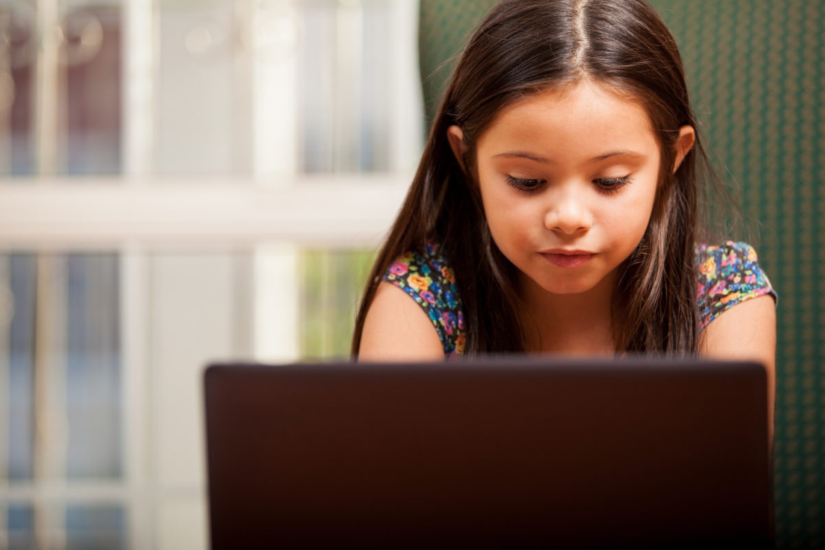 young girl looking at computer screen
