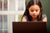 young girl looking at computer screen