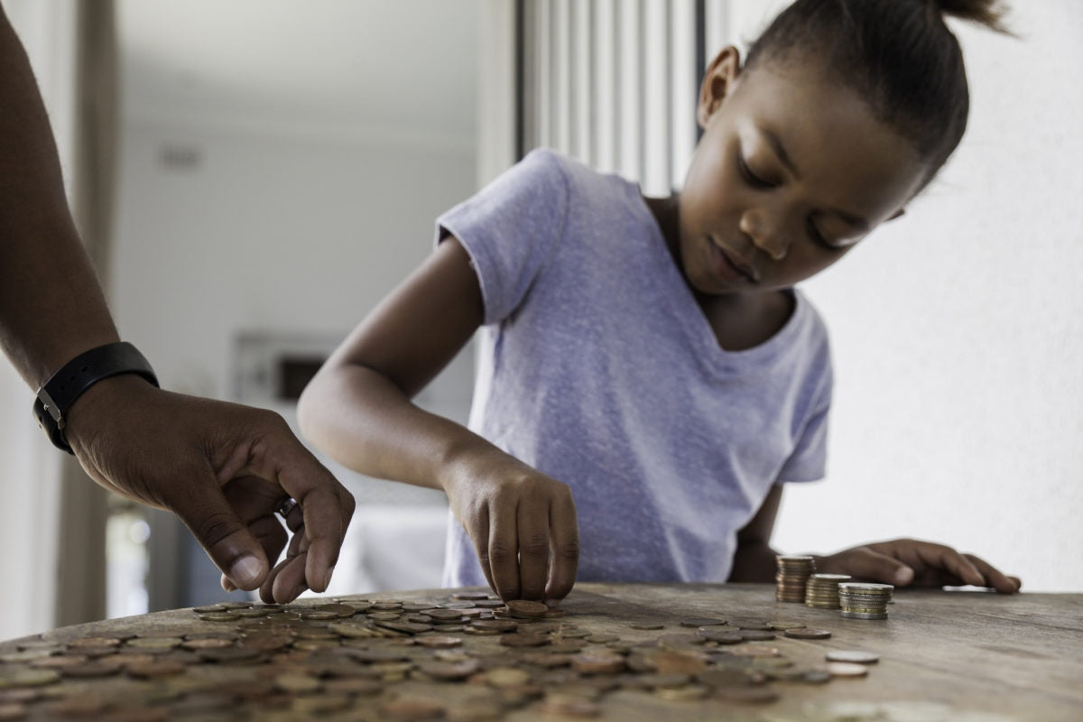 young girl collecting and counting coins