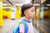 Japanese boy looking at something wearing school bag