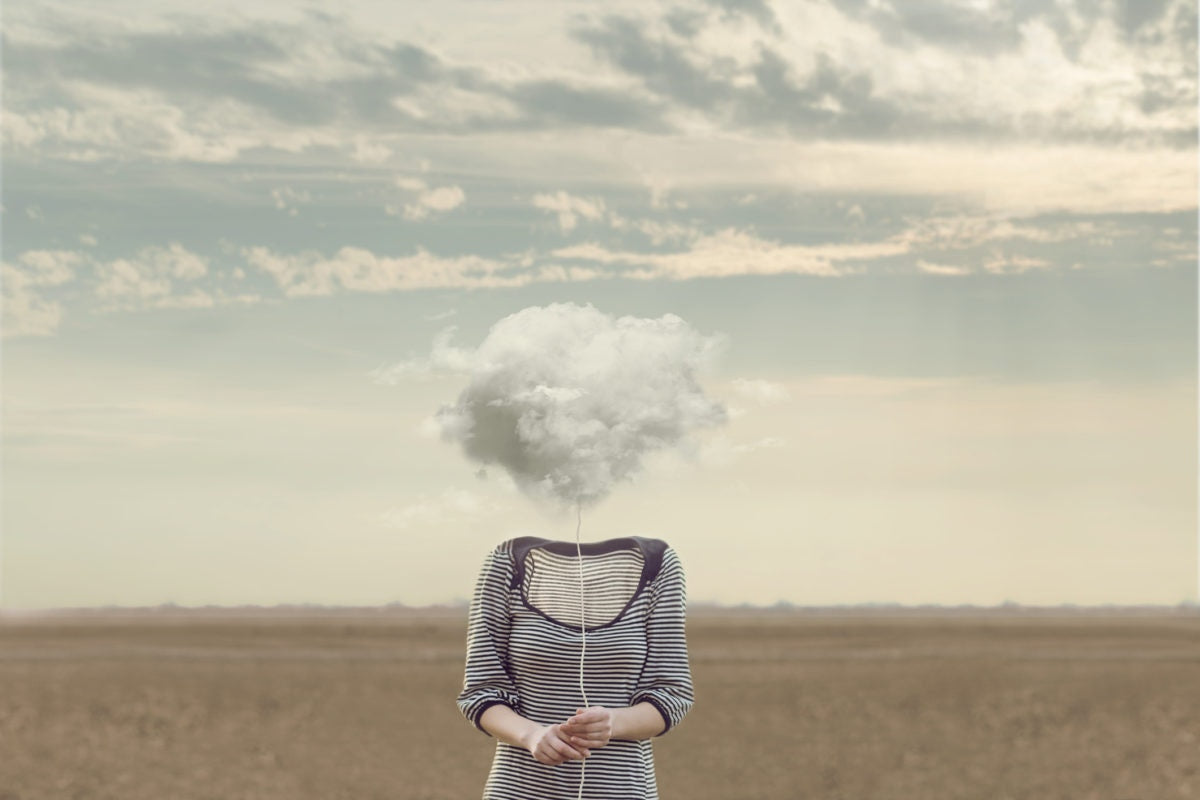 A girl holding thread covering her face with cloud