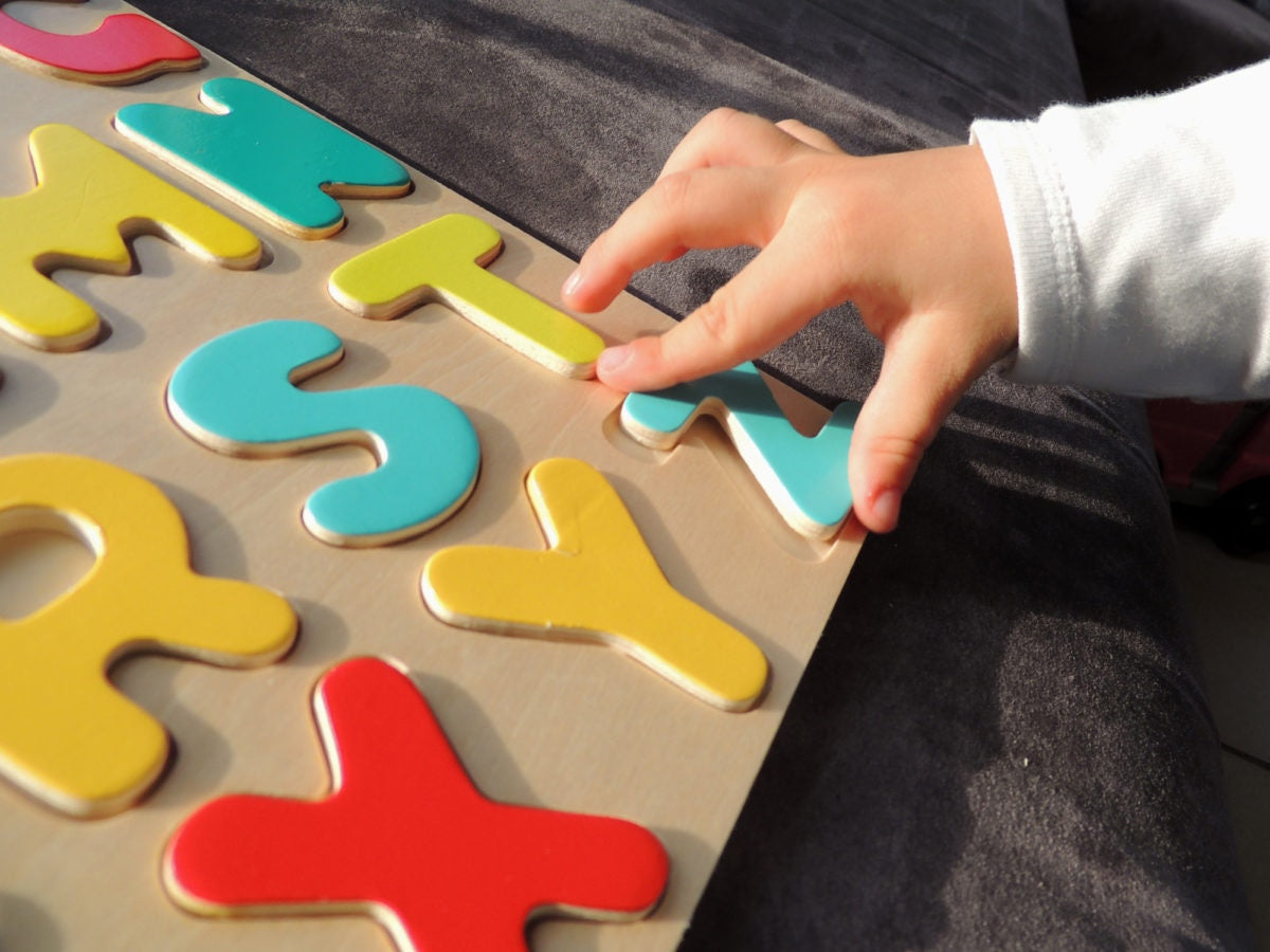 Child is rearranging alphabet letters