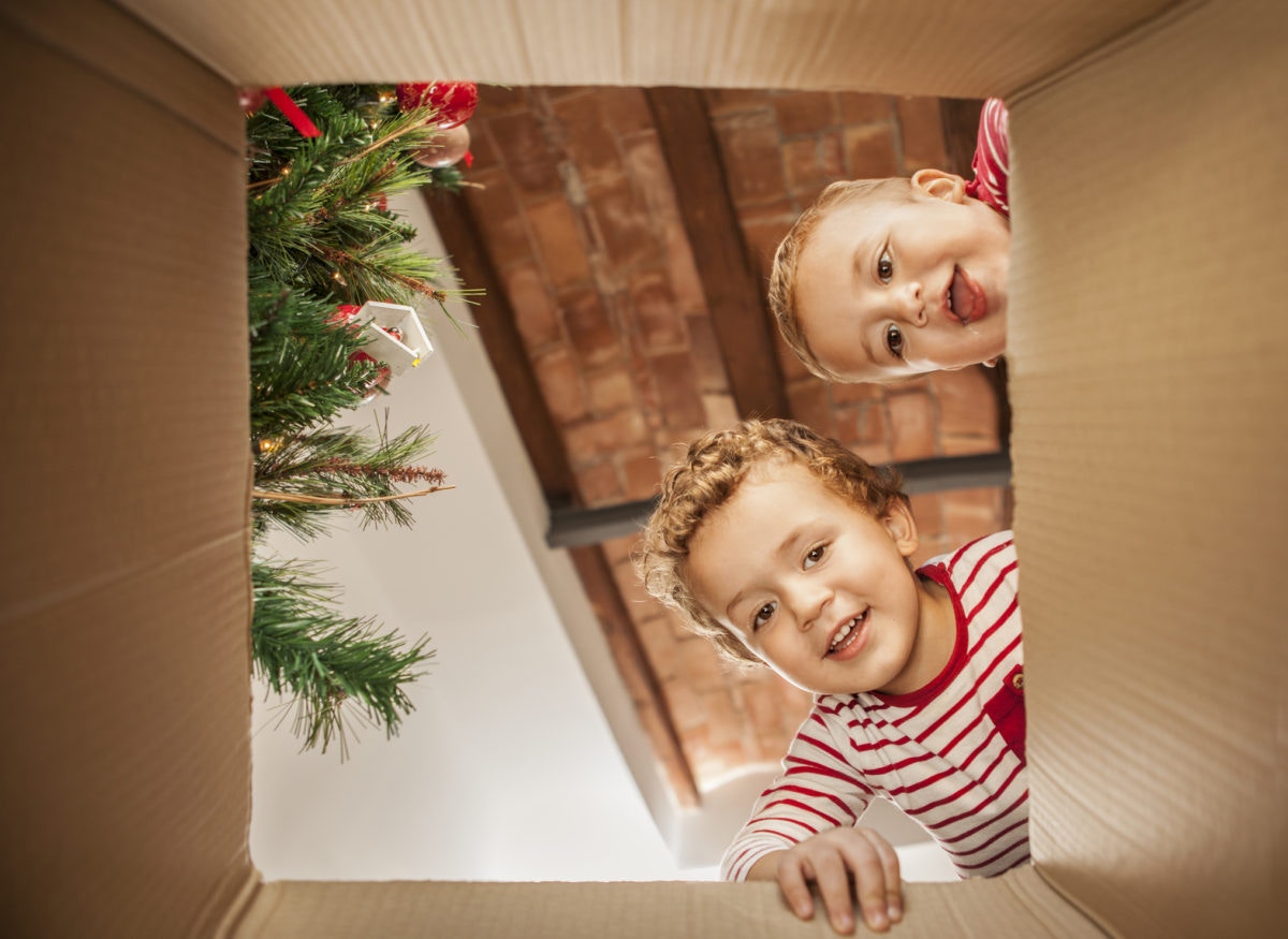 Two kid watching through an opened box