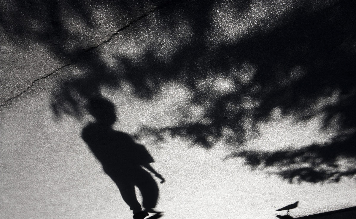 Boy standing in shadow