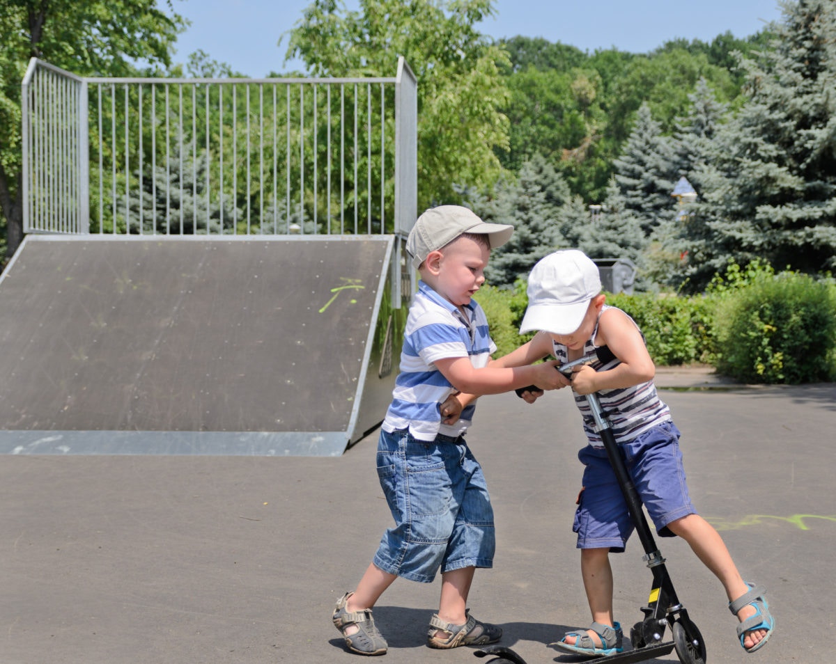 Kids fighting for a scooter