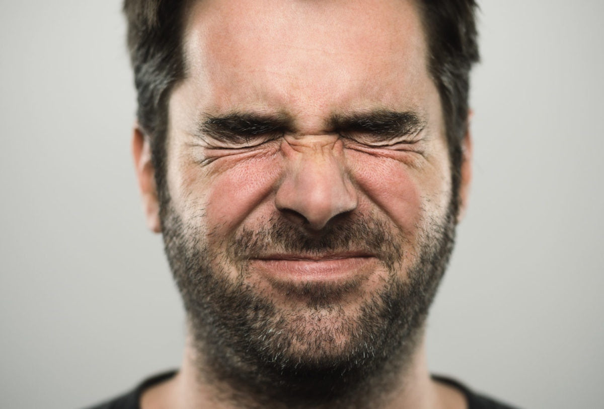 A person closed eye with beard