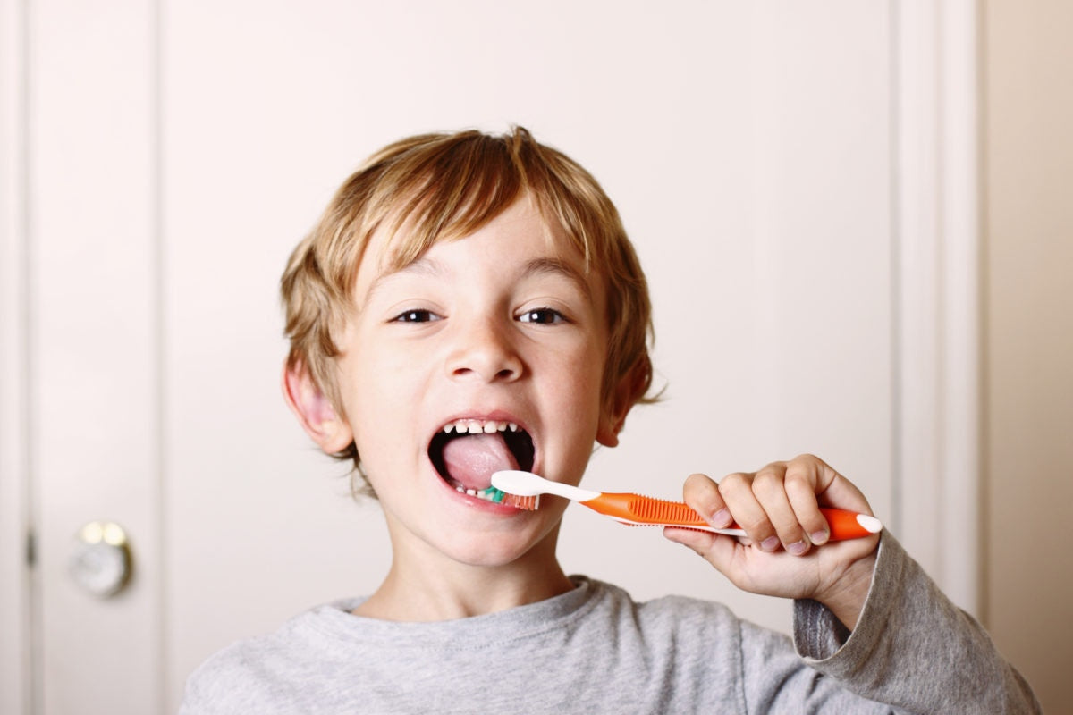 Little boy brushing his teeth