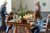 Two girls sitting in a dining hall with elder people blur image