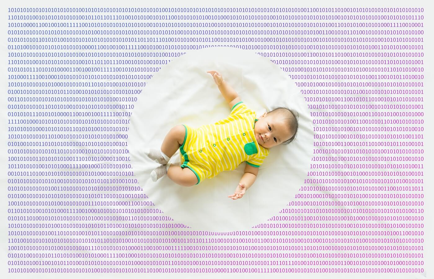 toddler in a bed sheet printed with binary digits