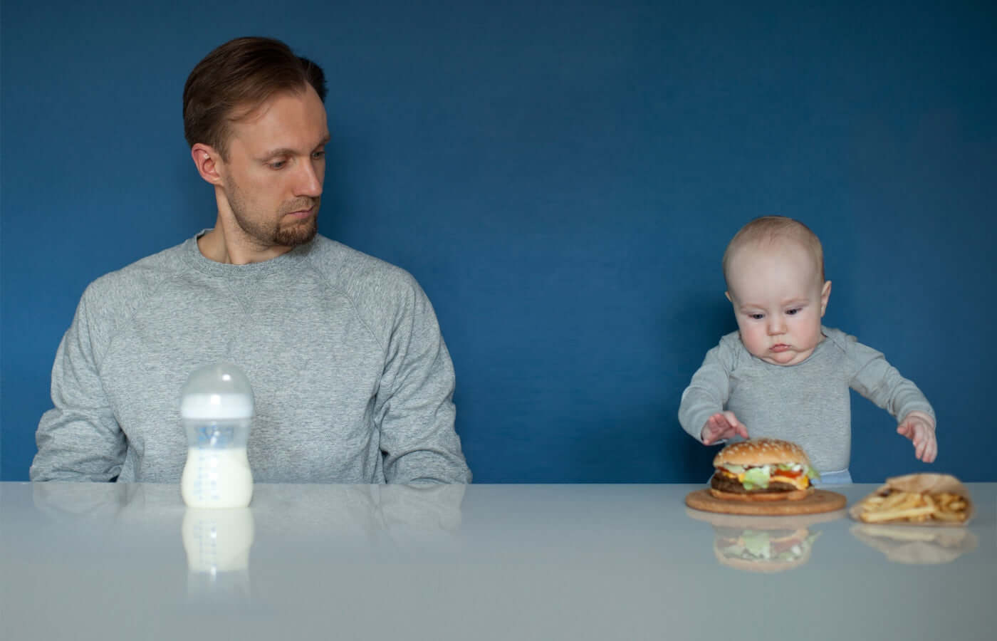 Father and child's food is exchanged,while father is stearing child food