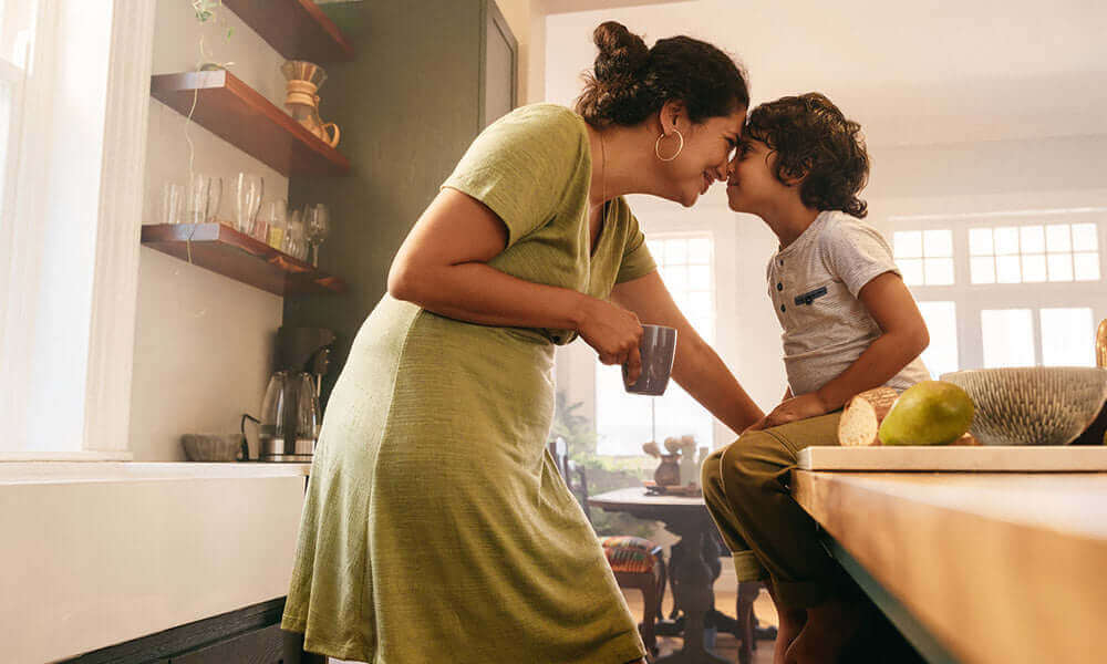 mother touching noses with her young son