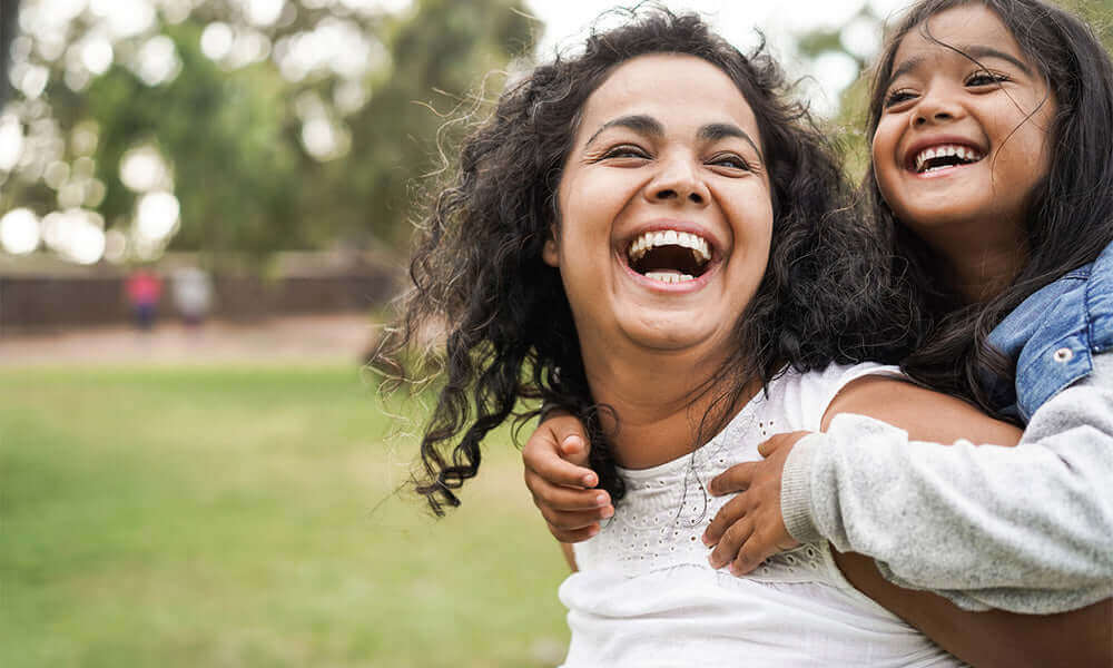 indian mother having fun with her daughter outdoor