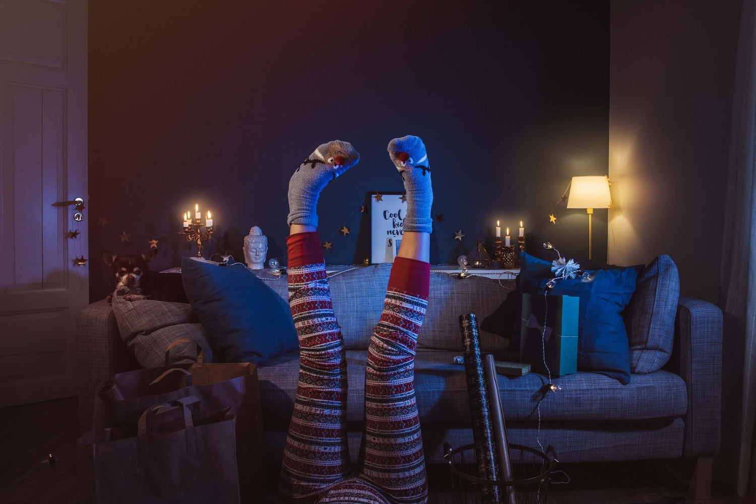 upside down image of women leg's wearing  flowered maroon pants and grey socks