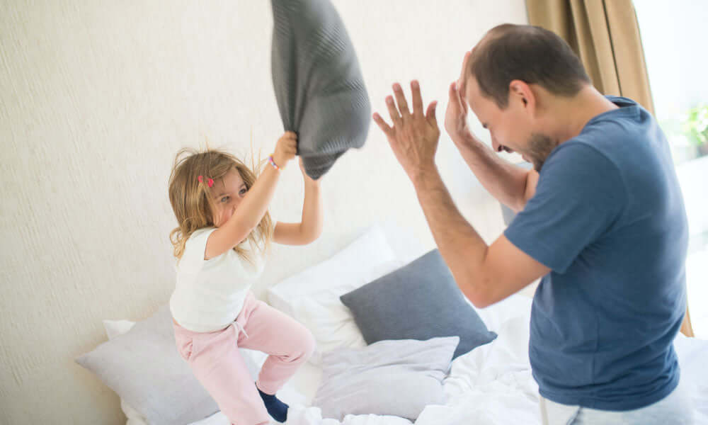 father and daughter pillow fight