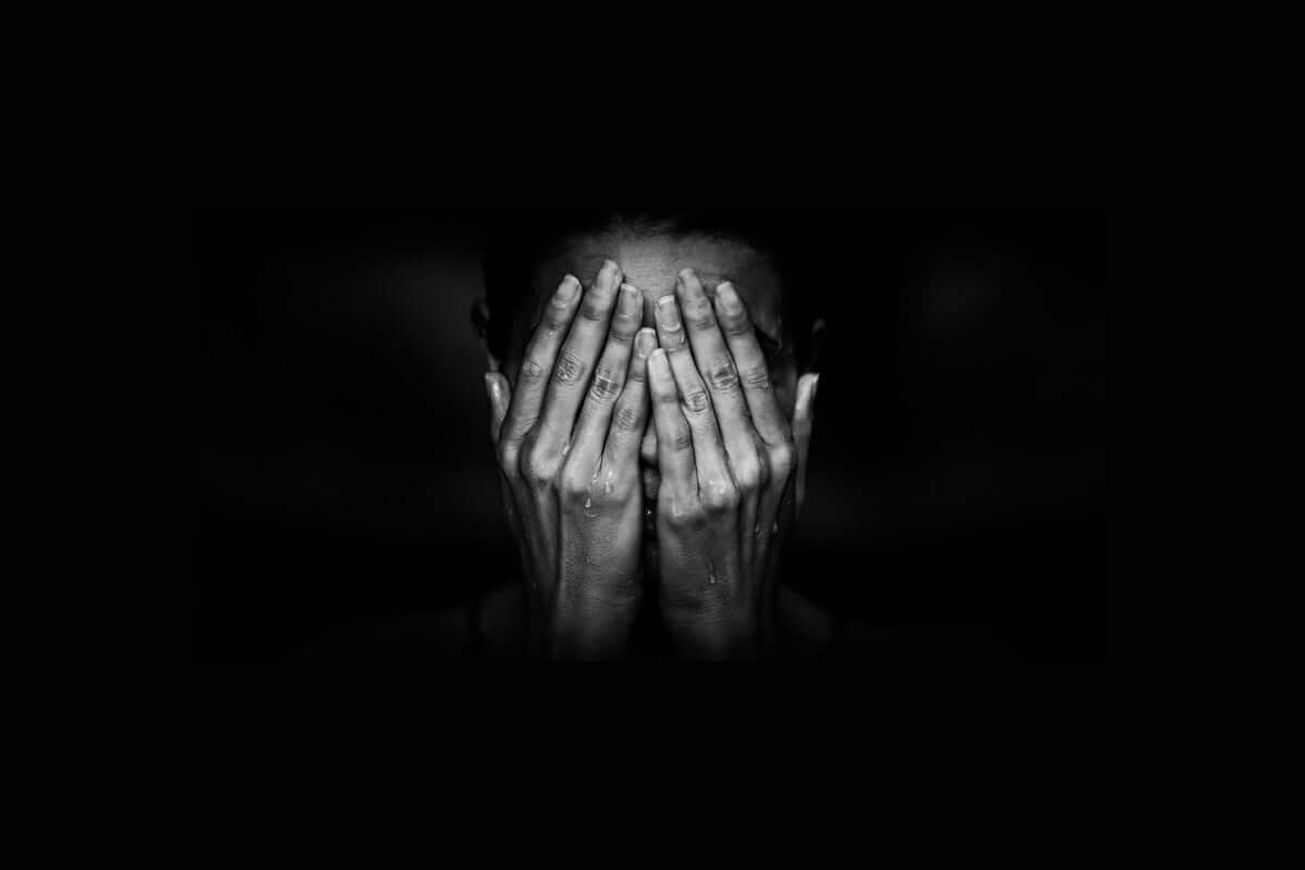 a person closing face with hand