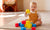 baby playing with colorful building blocks