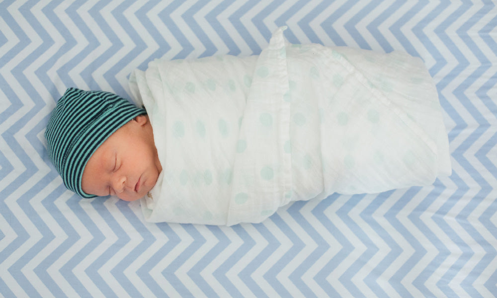 baby wrapped in a swaddle blanket