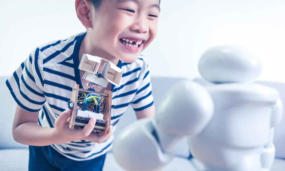 boy showing his own robot indoors 