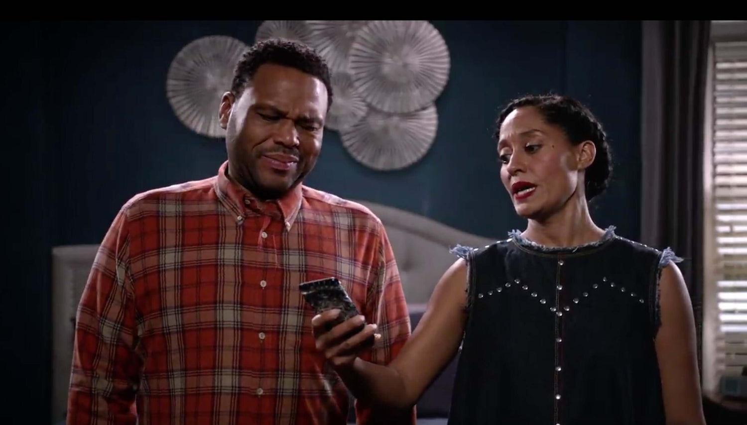 Annoyed couple looking at a smart phone
