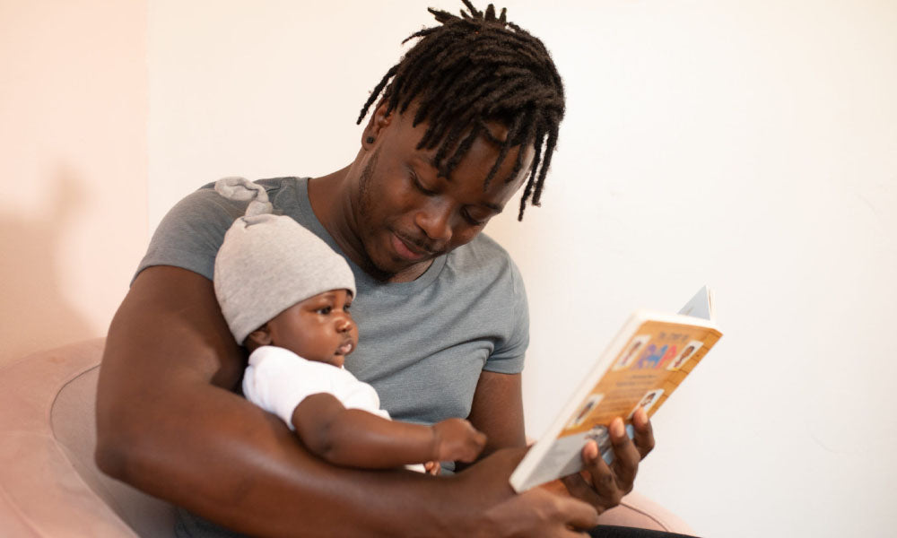 dad reading to baby son 