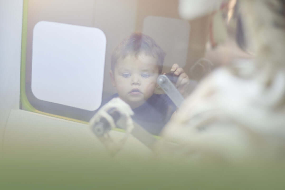 curious little boy looking out of the window