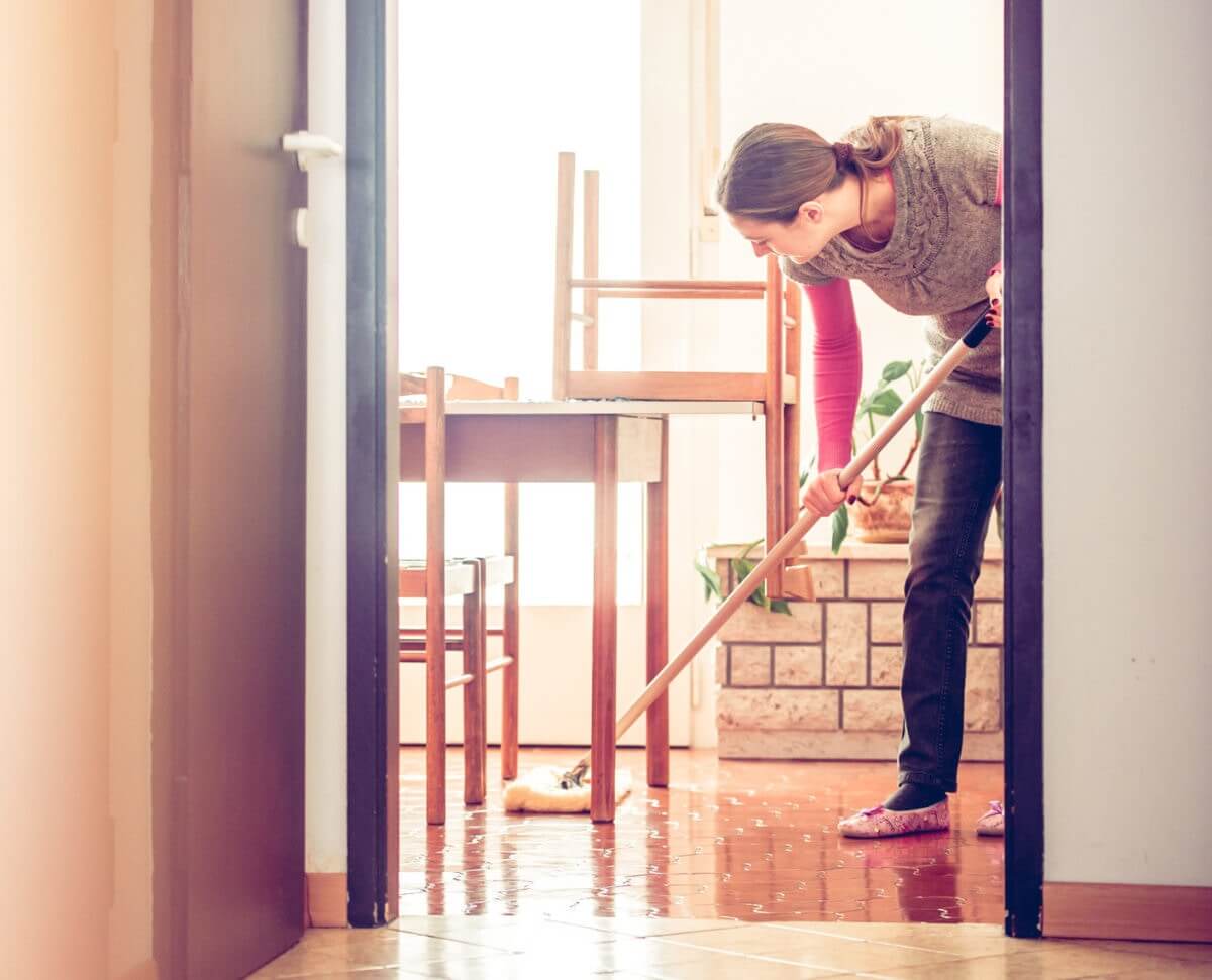 Woman mopping the living room floor 