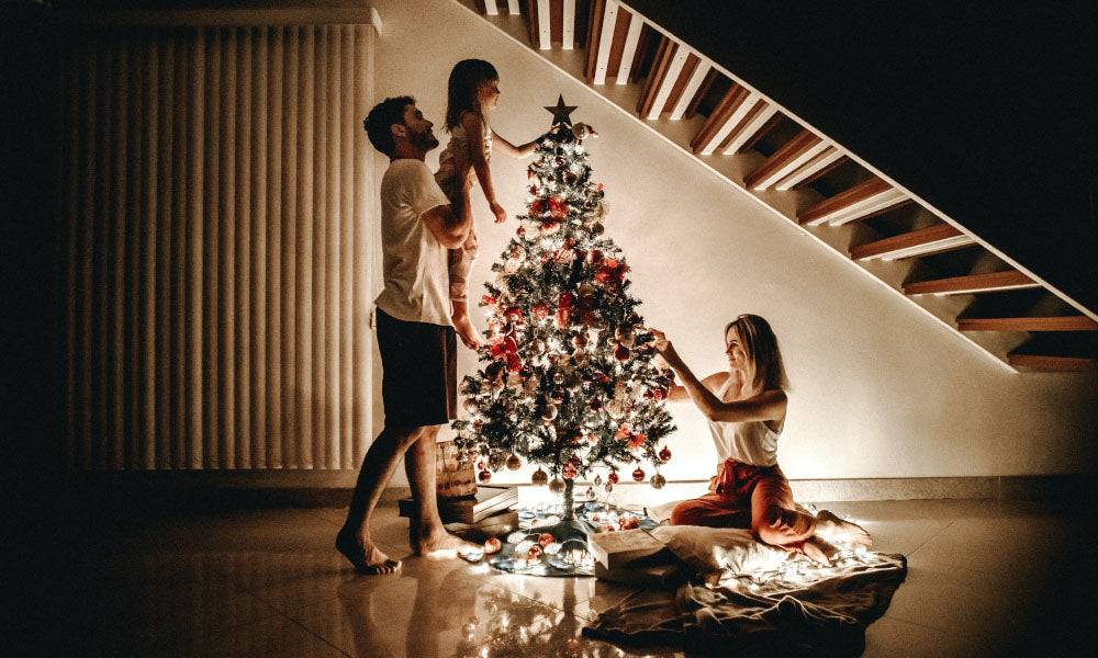 family decorating their christmas tree