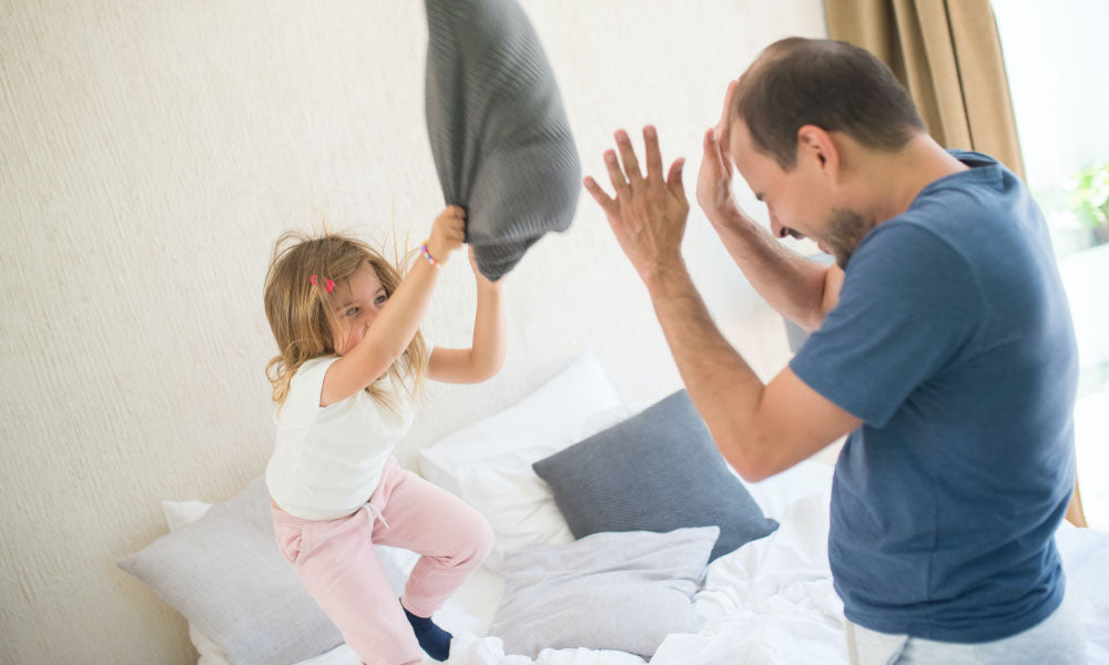 father and daughter pillow fight