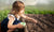 girl planting seeds in the ground 