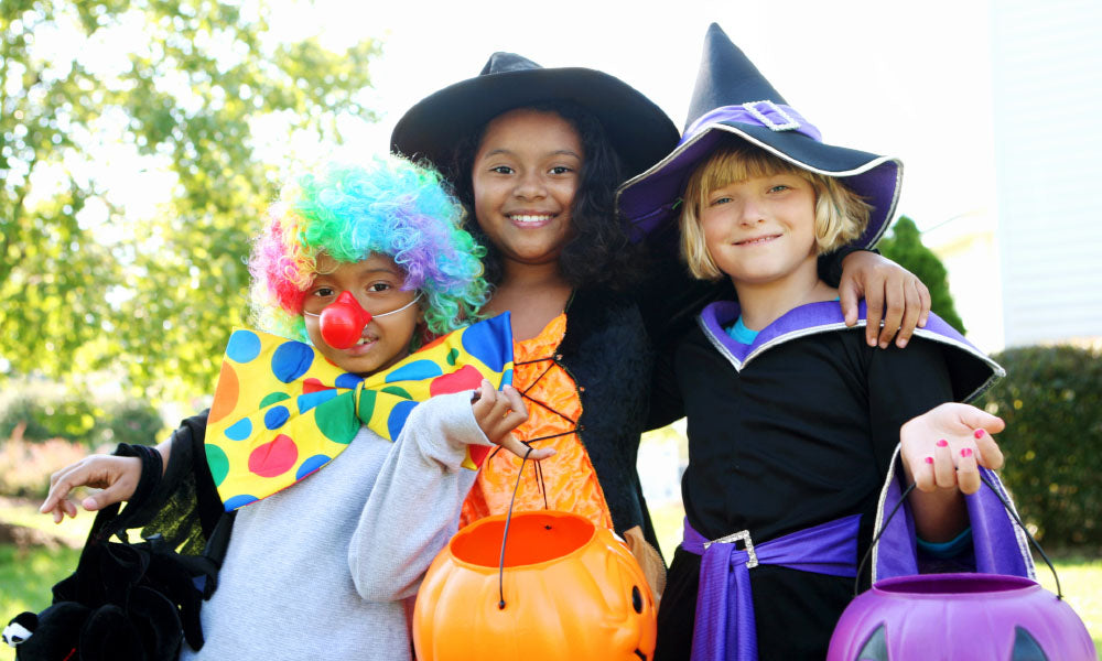 halloween kids in costumes smiling