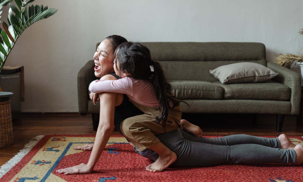 woman and girl doing yoga
