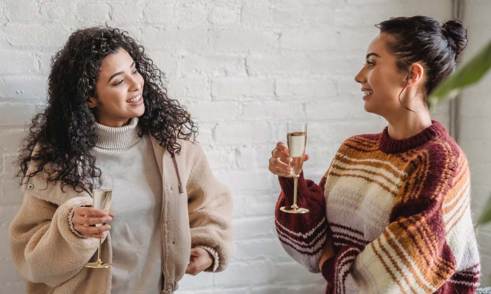 two young woman having a glass of champagne