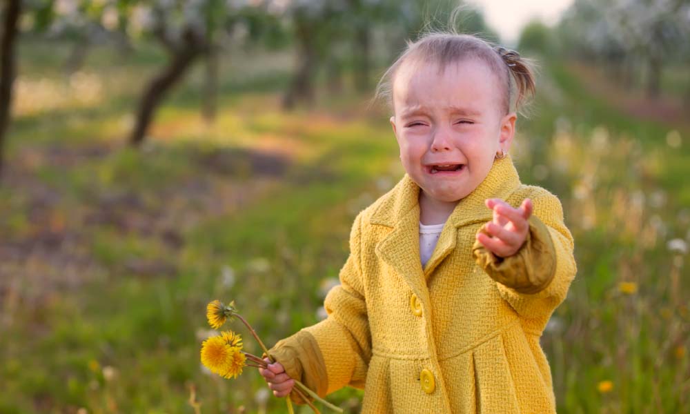 girl crying in a field