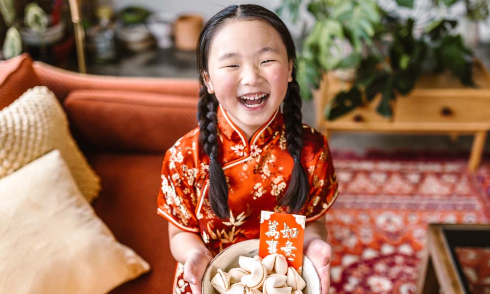 young girl hold fortune cookies