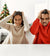 couple sitting on the table by christmas tree suffering from headache