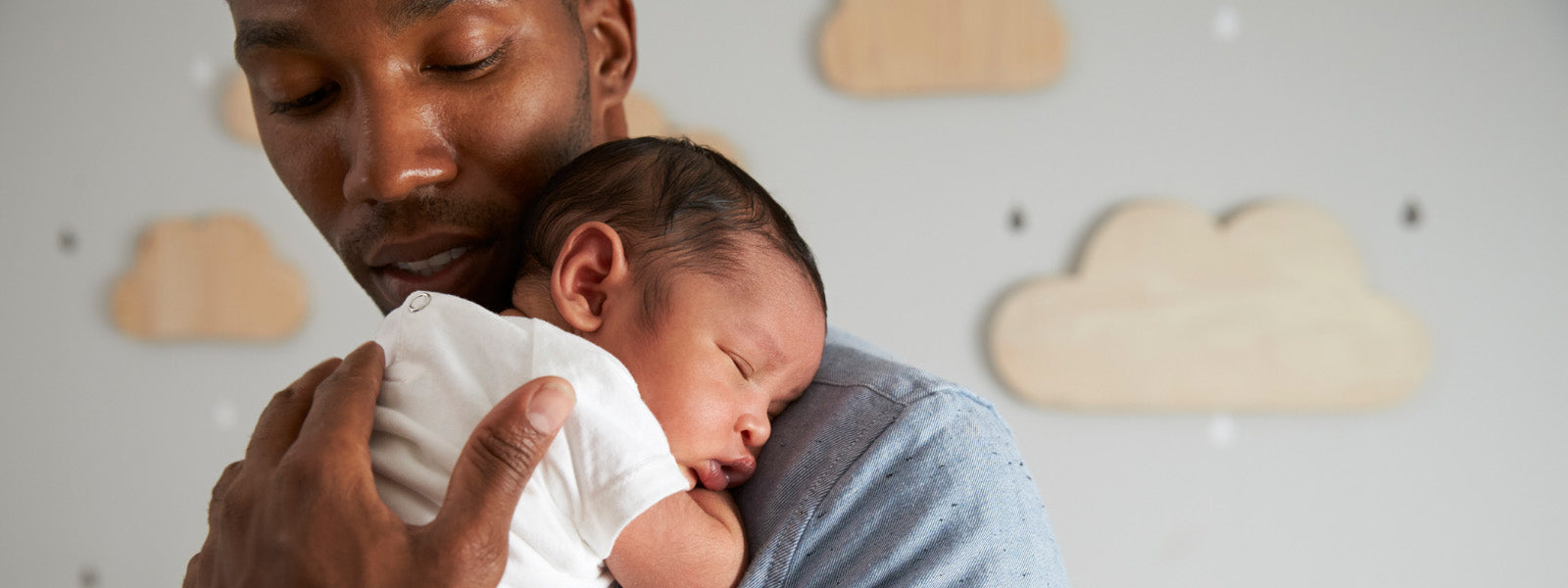 young father holding baby