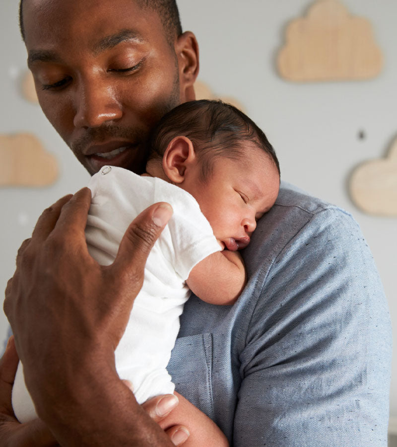 young father holding baby